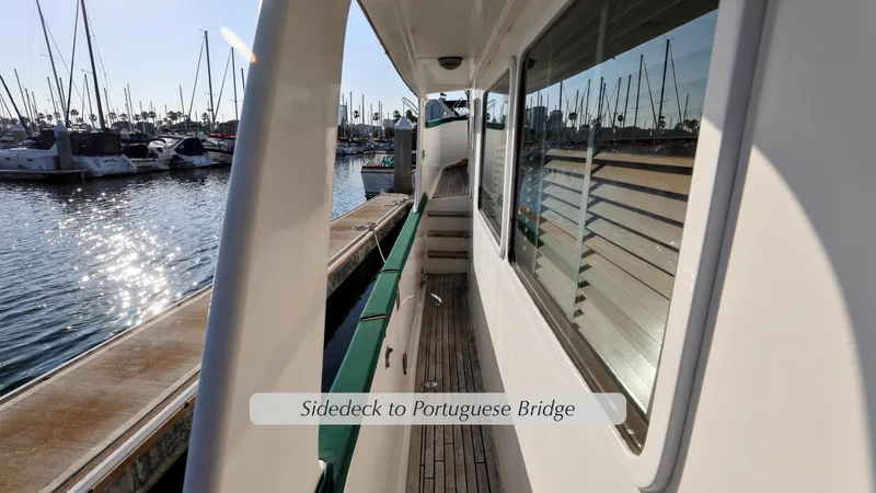 Slide: The Image of 1988 DeFever Pilot House side deck leading to Portuguese bridge, docked at marina. - 19
