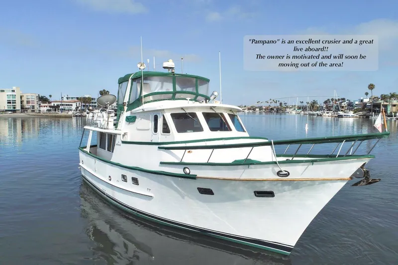 Slide: The Image of 1988 DeFever Pilot House yacht on calm water, ideal for cruising and living aboard. - 2
