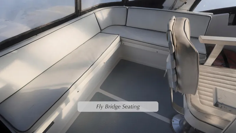 Slide: The Image of 1988 DeFever Pilot House flybridge seating with cushioned benches and captain's chair. - 23