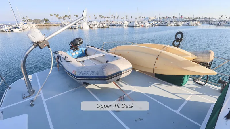 Slide: The Image of 1988 DeFever Pilot House upper aft deck with dinghy and kayaks. - 25