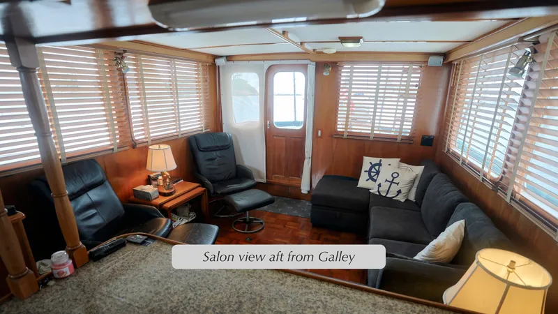 Slide: The Image of Salon view of 1988 DeFever Pilot House with cozy seating and nautical decor. - 5