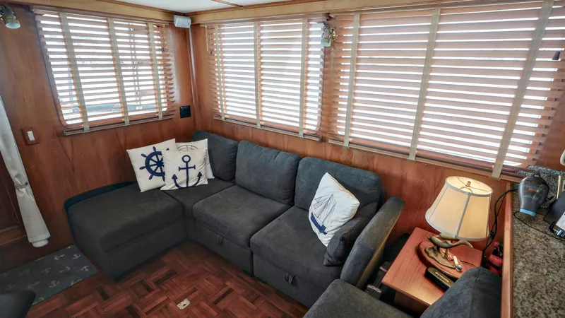 Slide: The Image of Cozy interior of 1988 DeFever Pilot House with nautical-themed decor and wooden blinds. - 6