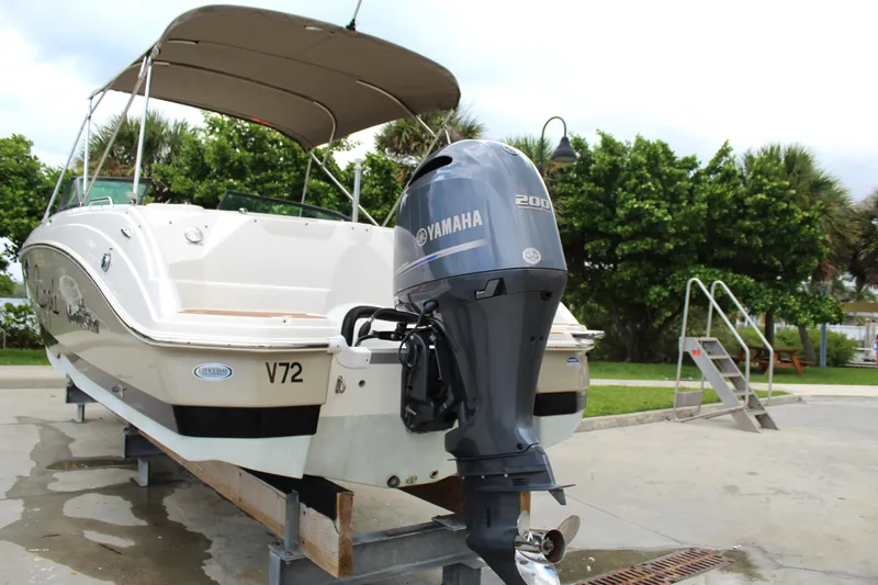 Slide: The Image of 2017 NauticStar 243DC Sport Deck boat with Yamaha outboard motor on a trailer. - 17