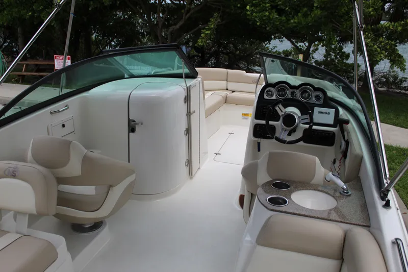 Slide: The Image of 2017 NauticStar 243DC Sport Deck boat interior with seating and steering console. - 2
