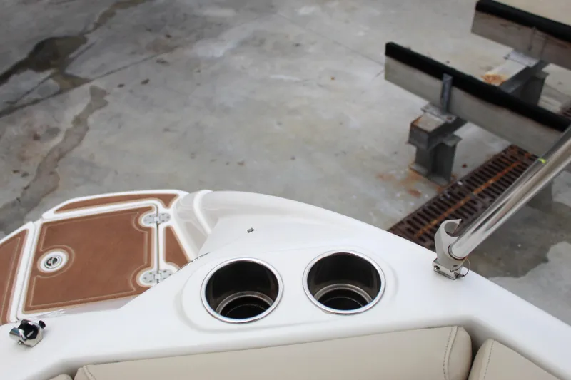 Slide: The Image of 2017 NauticStar 243DC Sport Deck boat interior with cup holders and seating. - 23