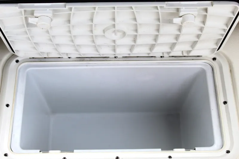 Slide: The Image of Open storage compartment on 2017 NauticStar 243DC Sport Deck boat. - 25