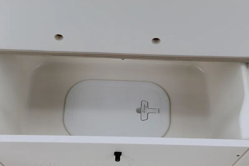 Slide: The Image of 2017 NauticStar 243DC Sport Deck storage compartment interior. - 27