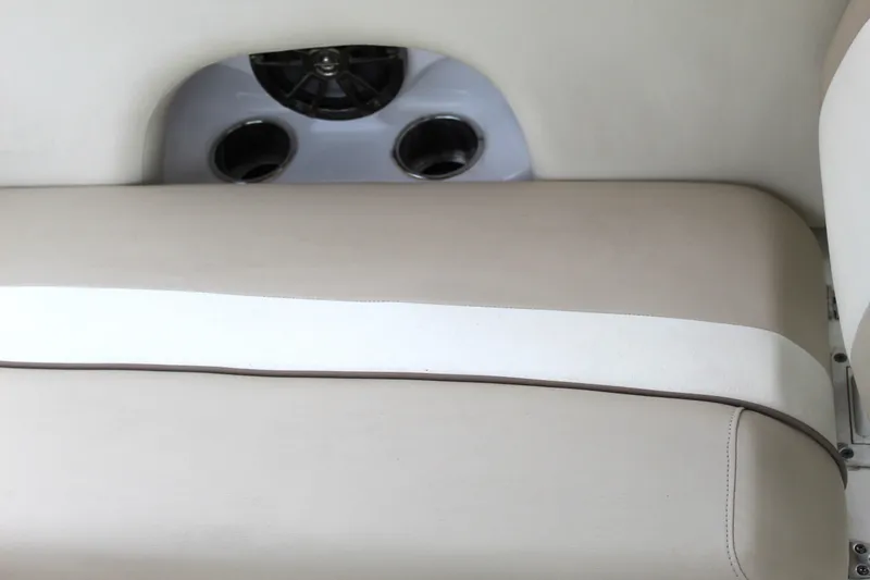 Slide: The Image of Beige seating on 2017 NauticStar 243DC Sport Deck boat with speaker and cup holders. - 29