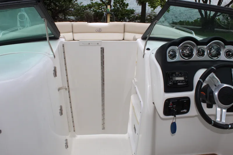 Slide: The Image of 2017 NauticStar 243DC Sport Deck interior with steering wheel and dashboard controls. - 3