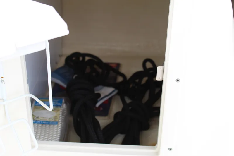 Slide: The Image of Storage compartment with ropes on a 2017 NauticStar 243DC Sport Deck boat. - 36