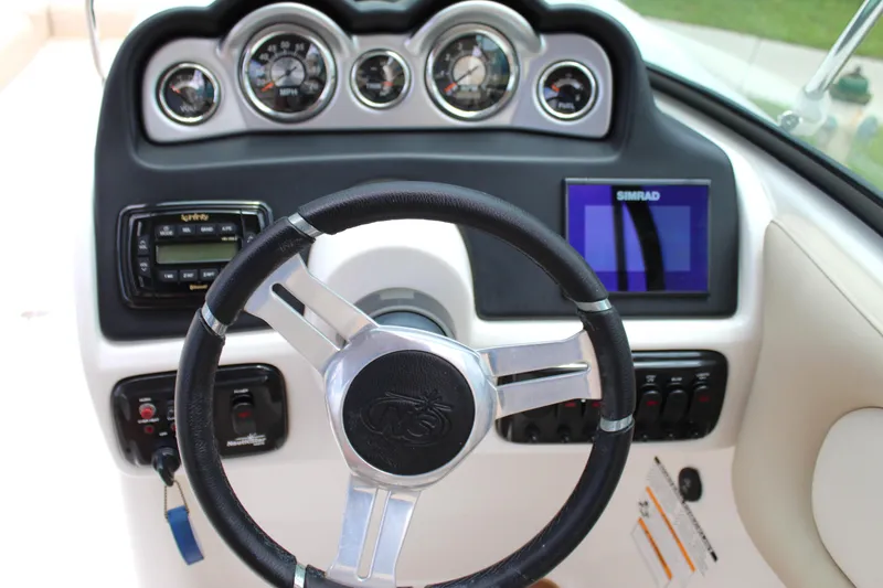 Slide: The Image of 2017 NauticStar 243DC Sport Deck dashboard with steering wheel and gauges. - 38