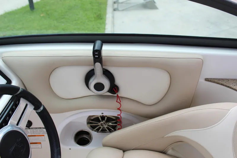 Slide: The Image of 2017 NauticStar 243DC Sport Deck interior with steering wheel and speaker system. - 5