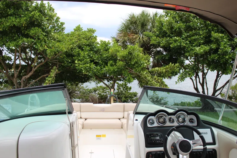 Slide: The Image of 2017 NauticStar 243DC Sport Deck boat interior with lush greenery background. - 9