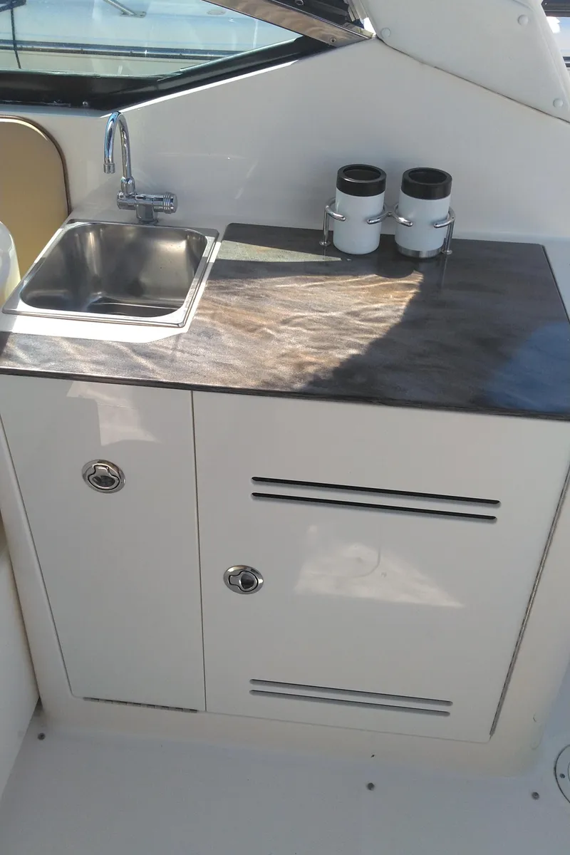 Slide: The Image of 2014 Sea Ray 300 SLX boat kitchenette with sink and storage. - 14