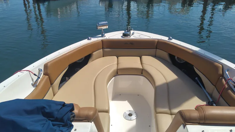 Slide: The Image of 2014 Sea Ray 300 SLX boat with tan seating, docked on calm water. - 19
