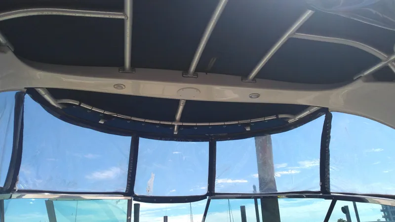 Slide: The Image of 2014 Sea Ray 300 SLX boat canopy and windshield under clear blue sky. - 20