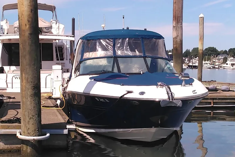 Slide: The Image of 2014 Sea Ray 300 SLX boat docked at marina under clear sky. - 3