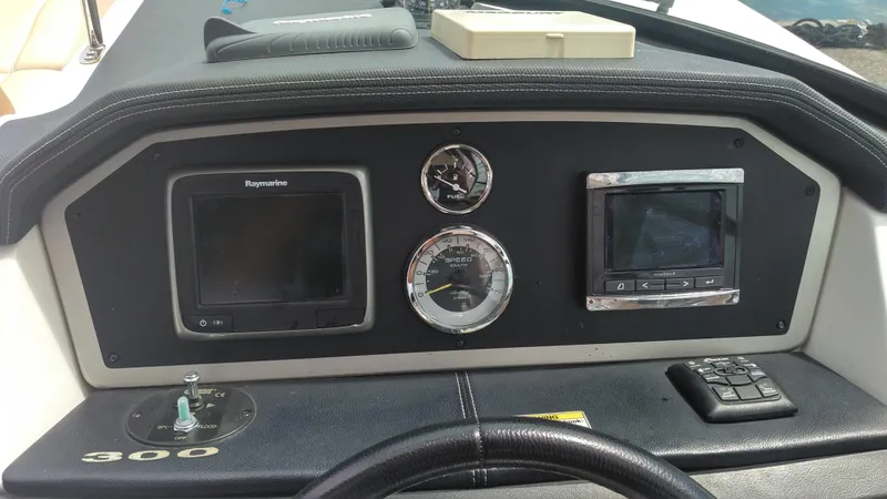 Slide: The Image of Dashboard of 2014 Sea Ray 300 SLX boat with navigation instruments. - 34