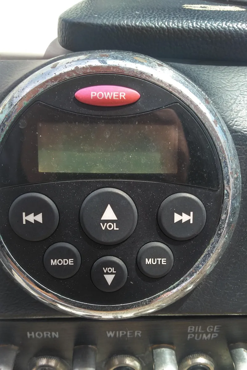 Slide: The Image of Boat control panel with power button and volume controls, Sea Ray 300 SLX 2014. - 40