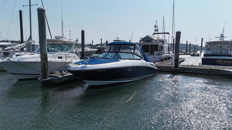 Slide: The Image of 2014 Sea Ray 300 SLX boat docked at a marina, surrounded by other vessels. - 45