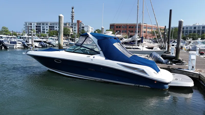Slide: The Image of 2014 Sea Ray 300 SLX boat docked at marina with blue cover. - 46