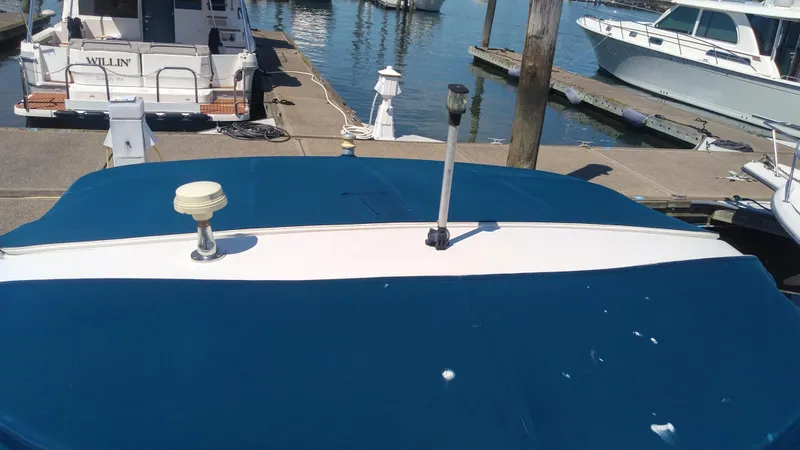 Slide: The Image of 2014 Sea Ray 300 SLX boat docked at marina with blue cover. - 5