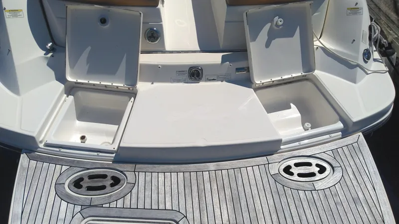 Slide: The Image of 2014 Sea Ray 300 SLX boat stern with open storage compartments and swim platform. - 6
