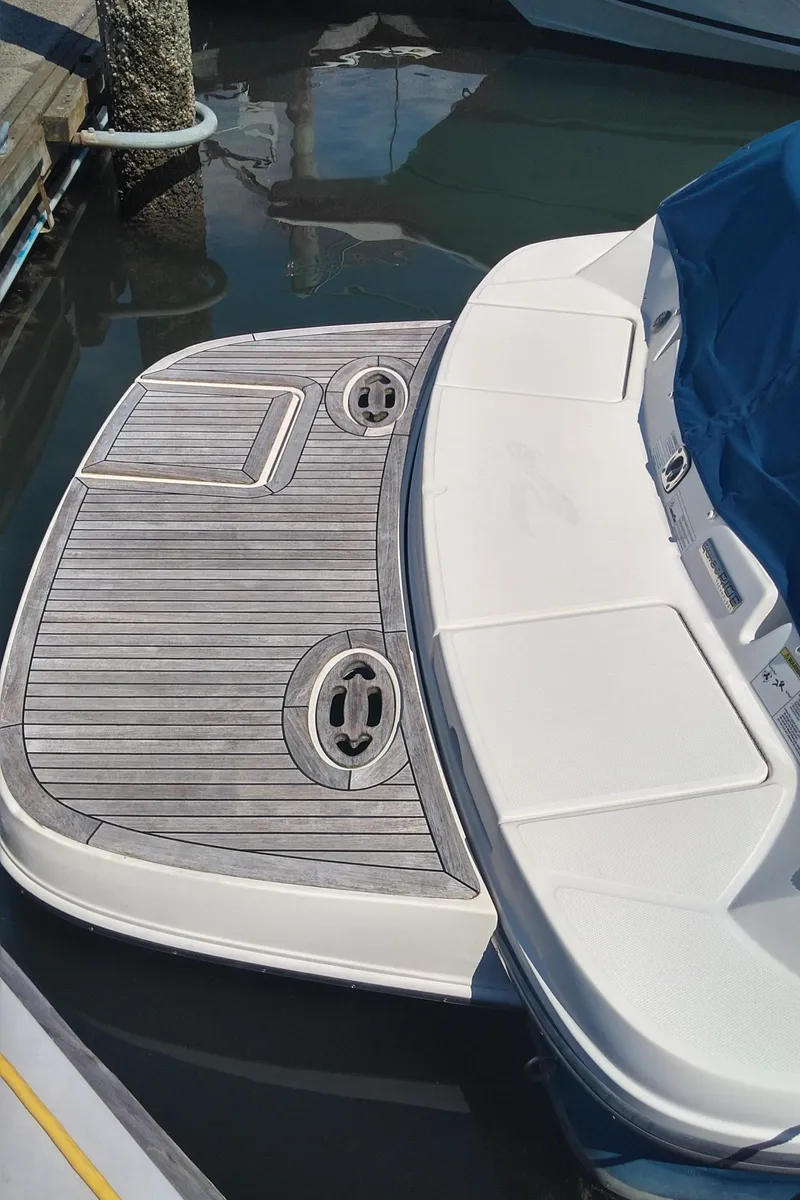 Slide: The Image of 2014 Sea Ray 300 SLX swim platform with teak decking in marina. - 9
