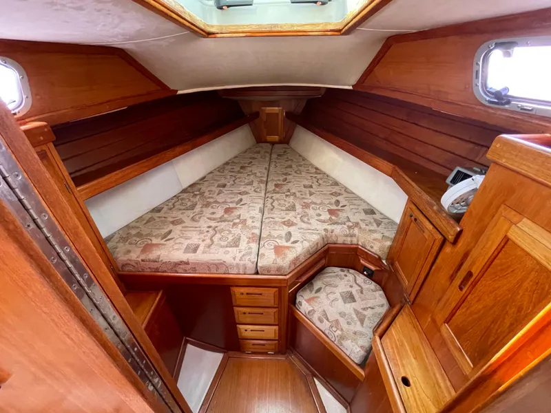 Slide: The Image of Cozy cabin interior of 1990 Ericson 38-200 sailboat with wood finish and patterned cushions. - 13