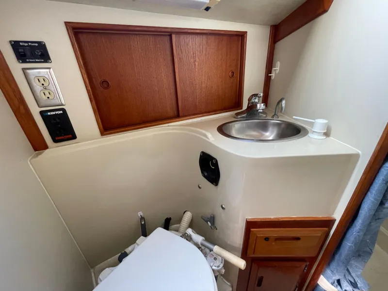 Slide: The Image of 1990 Ericson 38-200 yacht bathroom with sink, storage, and toilet. - 24
