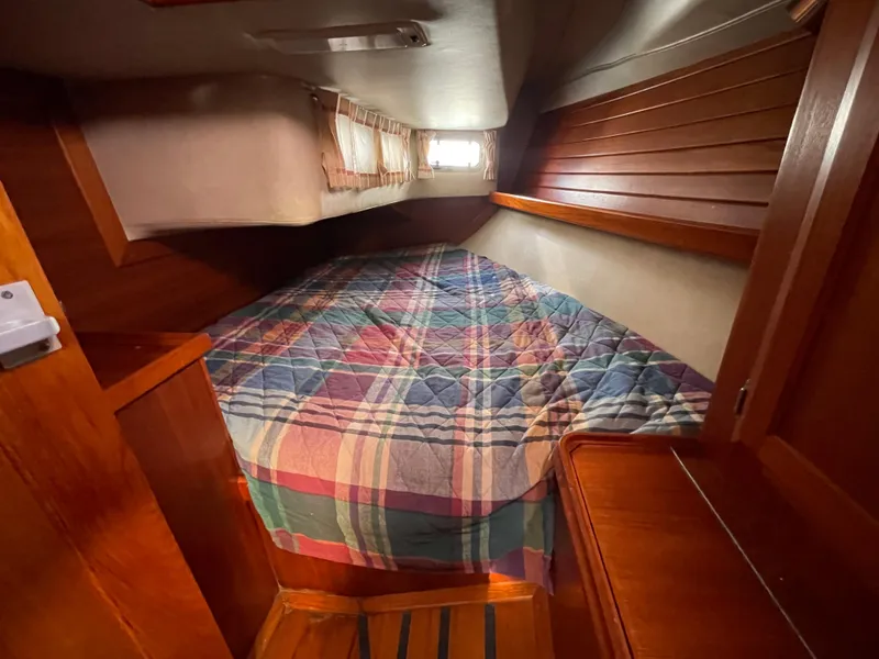Slide: The Image of Cozy cabin interior of 1990 Ericson 38-200 sailboat with colorful plaid bedding. - 26