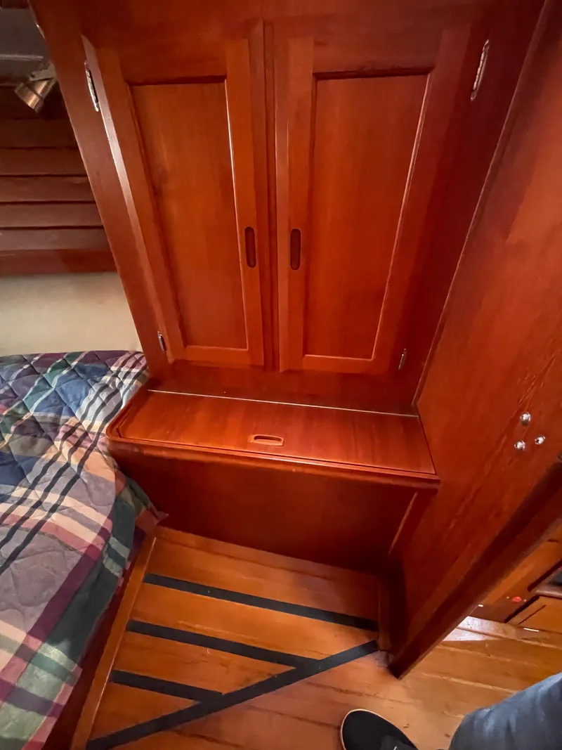 Slide: The Image of Wooden interior of a 1990 Ericson 38-200 sailboat with storage and bed. - 27