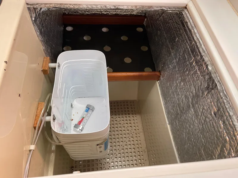 Slide: The Image of Storage compartment with insulation and a small washing machine on an Ericson 38-200 sailboat. - 29