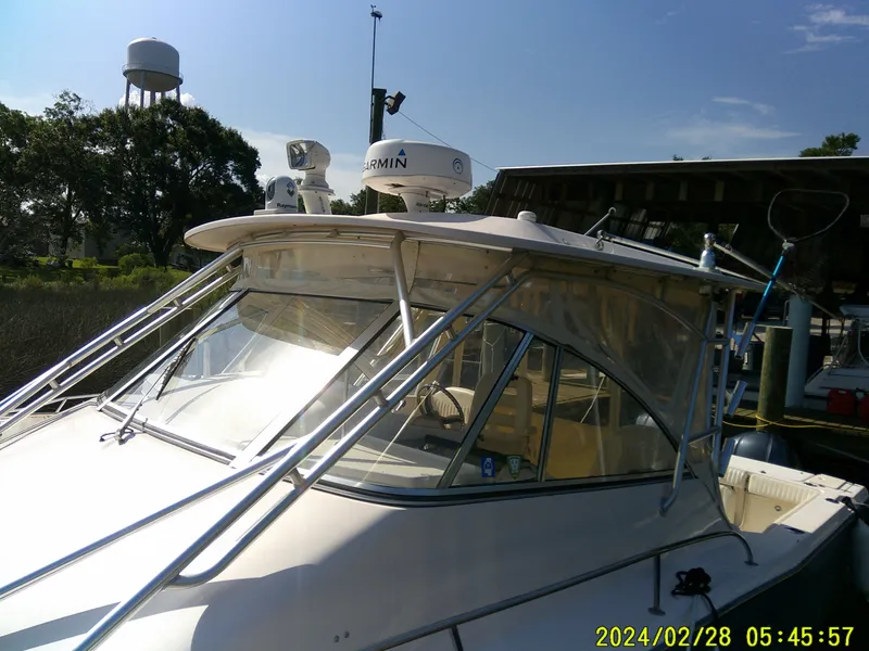 Slide: The Image of 2013 Grady-White 330 Express boat docked with radar equipment. - 10