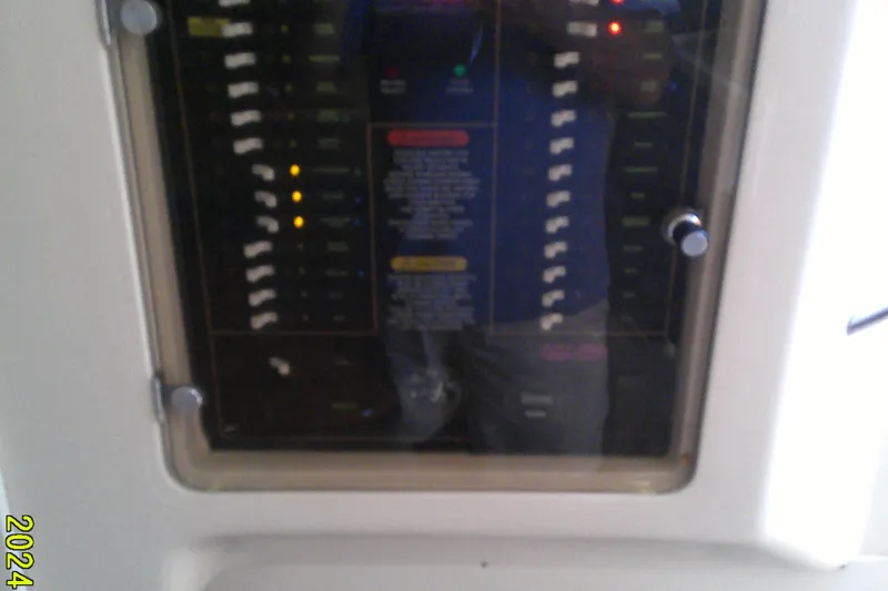 Slide: The Image of Control panel of a 2013 Grady-White 330 Express boat with switches and indicators. - 12