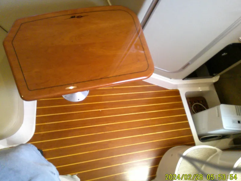 Slide: The Image of Interior of 2013 Grady-White 330 Express with wooden flooring and table. - 13