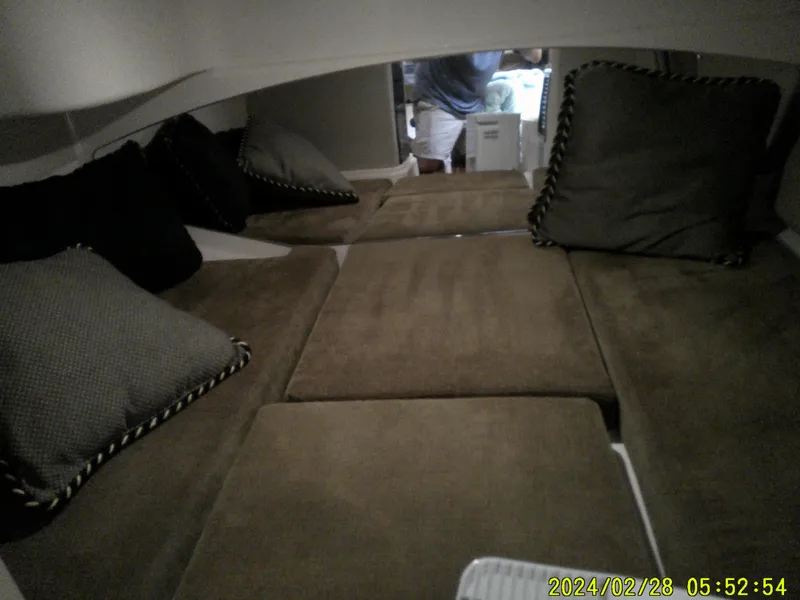 Slide: The Image of Interior cabin of 2013 Grady-White 330 Express with cushioned seating and pillows. - 16