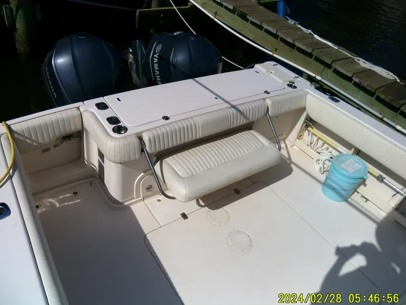 Slide: The Image of 2013 Grady-White 330 Express boat interior with Yamaha engines at dock. - 4