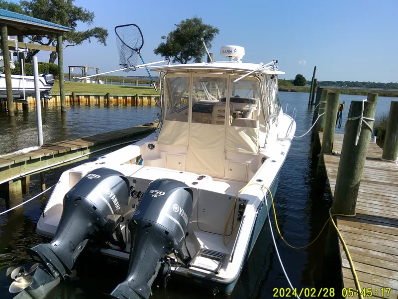 Slide: The Image of 2013 Grady-White 330 Express boat docked with twin Yamaha engines. - 6