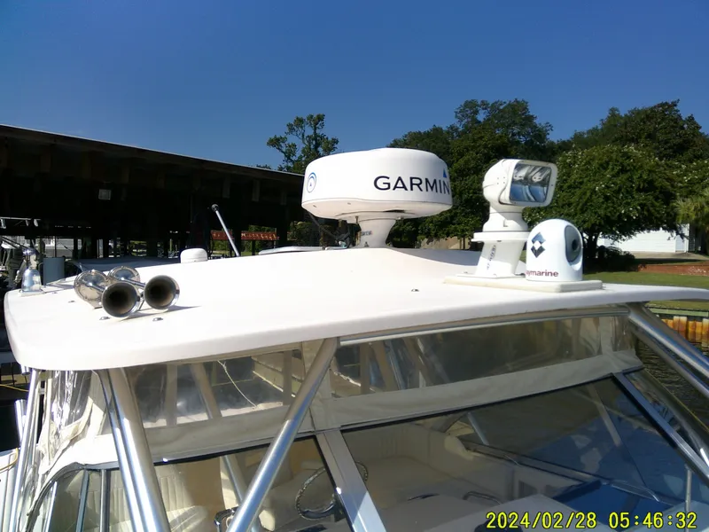 Slide: The Image of 2013 Grady-White 330 Express boat with Garmin radar and marine equipment on the roof. - 8