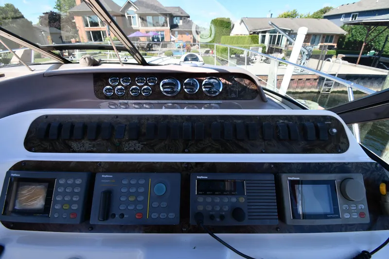 Slide: The Image of Control panel of a 1997 Sea Ray 400 Sundancer yacht, featuring navigation instruments. - 13
