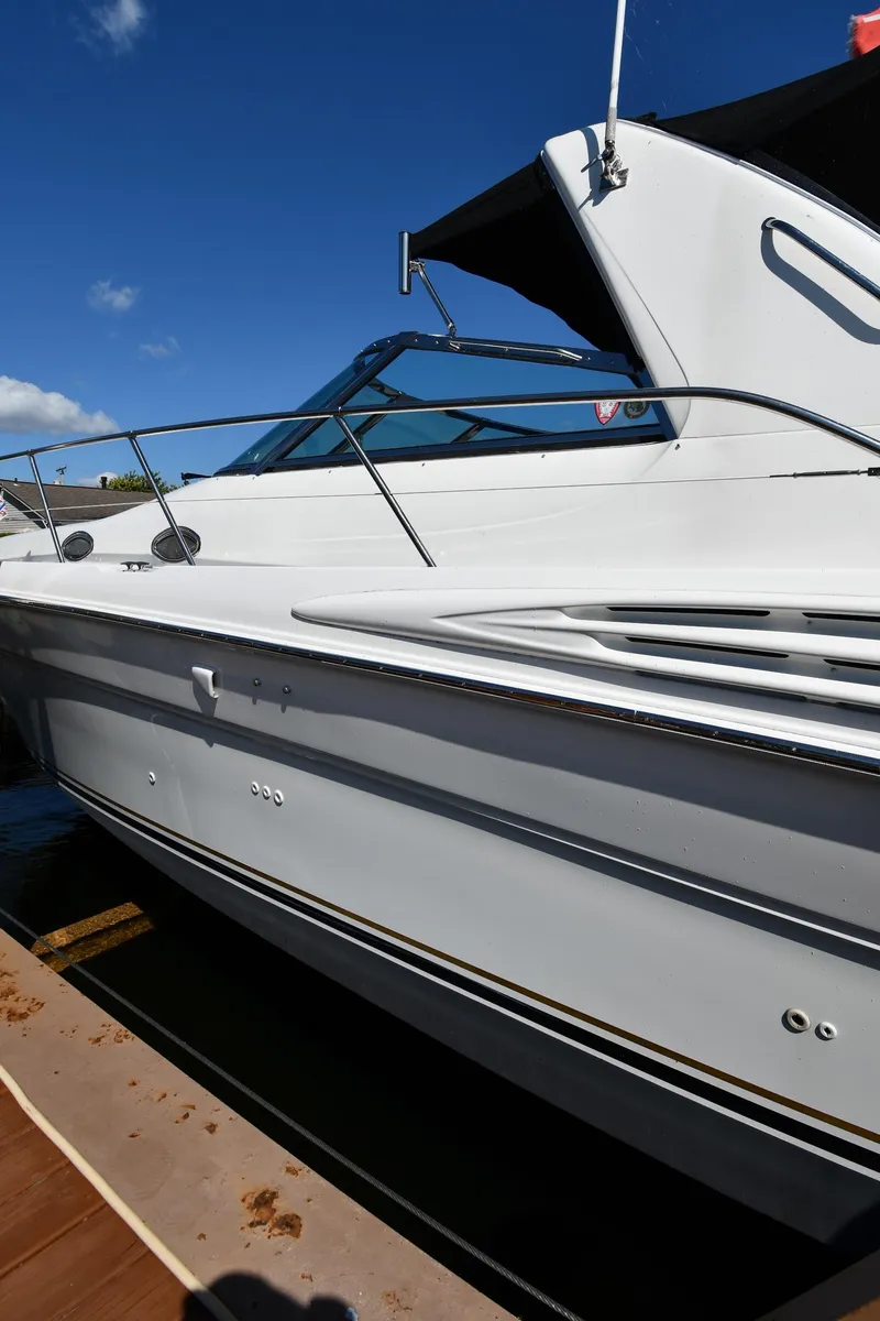 Slide: The Image of 1997 Sea Ray 400 Sundancer yacht docked under clear blue sky. - 2