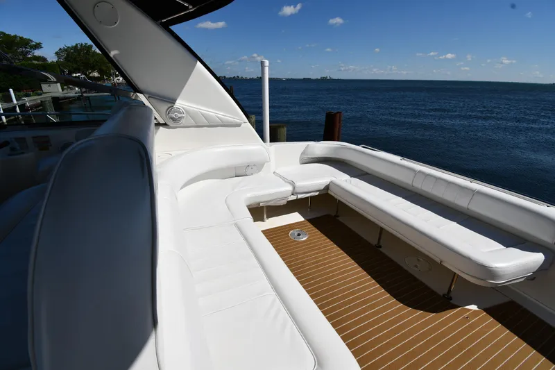 Slide: The Image of 1997 Sea Ray 400 Sundancer yacht with spacious white seating and ocean view. - 23