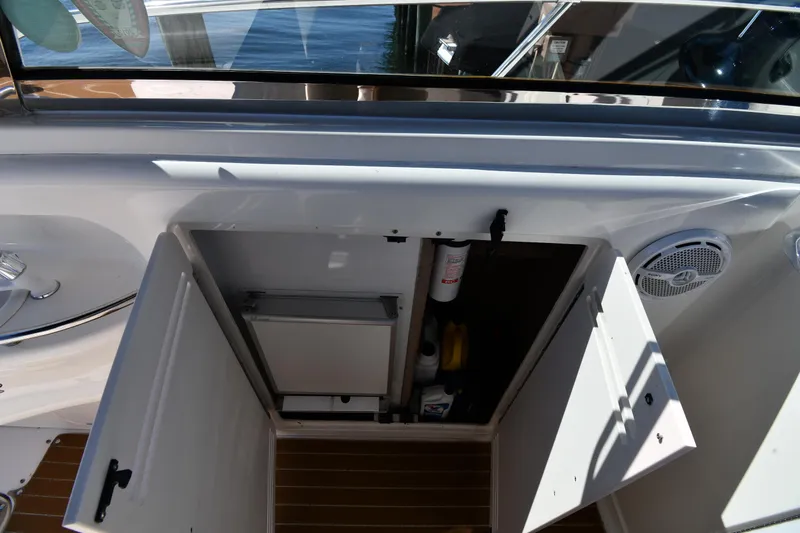 Slide: The Image of Open storage compartment on 1997 Sea Ray 400 Sundancer yacht deck. - 25