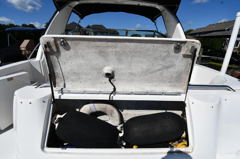 Slide: The Image of Open storage compartment on 1997 Sea Ray 400 Sundancer boat, showing interior space and equipment. - 26