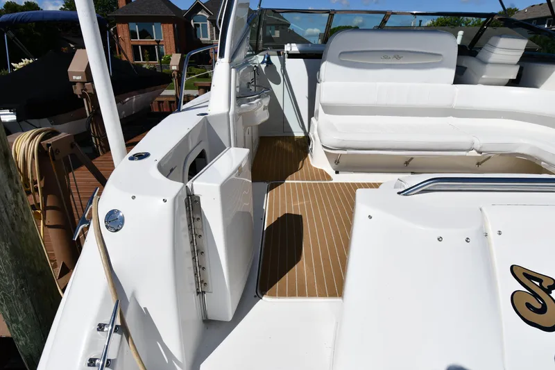 Slide: The Image of 1997 Sea Ray 400 Sundancer boat deck with white seating and wood flooring. - 27
