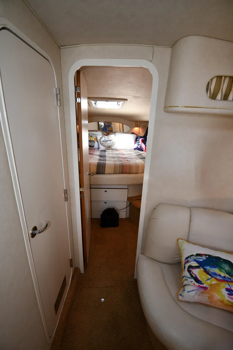 Slide: The Image of Interior of 1997 Sea Ray 400 Sundancer yacht, featuring cozy cabin and stylish decor. - 29