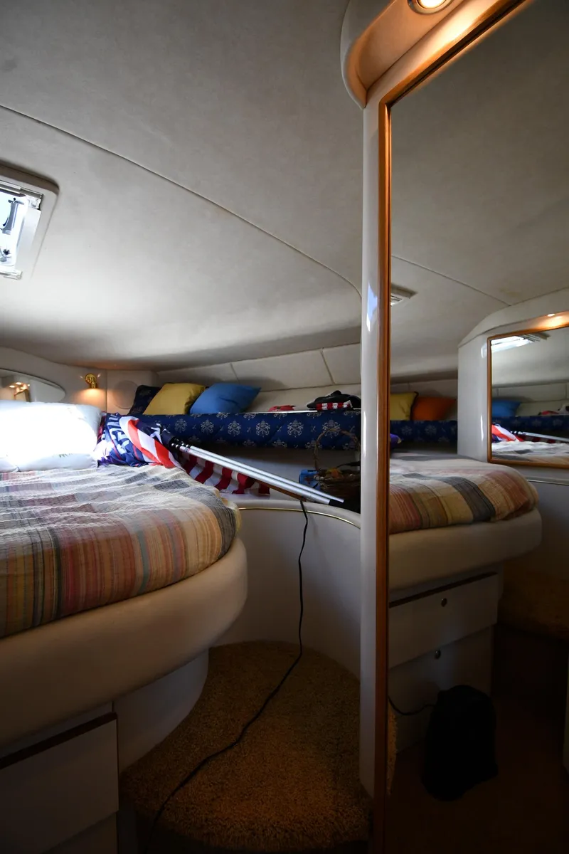 Slide: The Image of Interior cabin of a 1997 Sea Ray 400 Sundancer yacht with cozy bedding. - 31