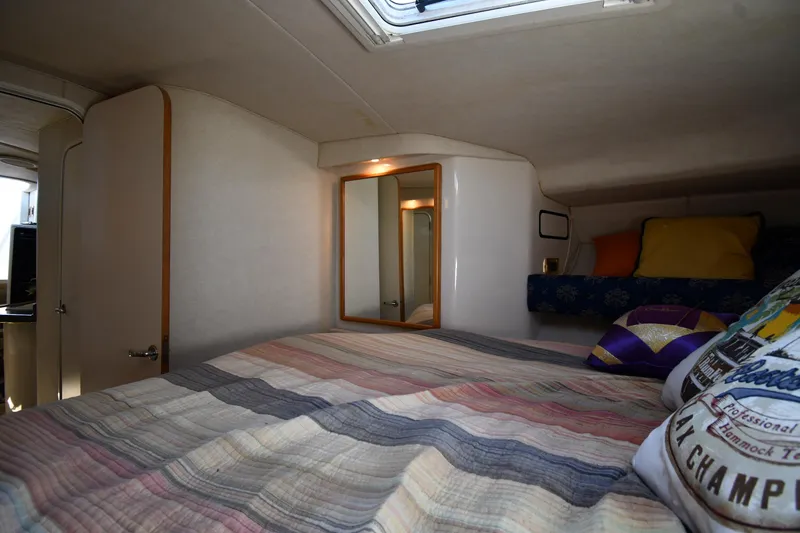 Slide: The Image of Cozy cabin interior of 1997 Sea Ray 400 Sundancer with bed and mirror. - 33