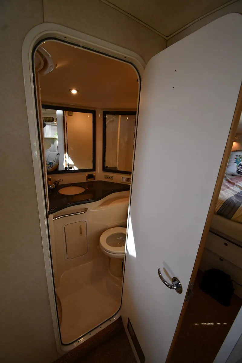 Slide: The Image of Bathroom interior of 1997 Sea Ray 400 Sundancer yacht, featuring sink and toilet. - 35
